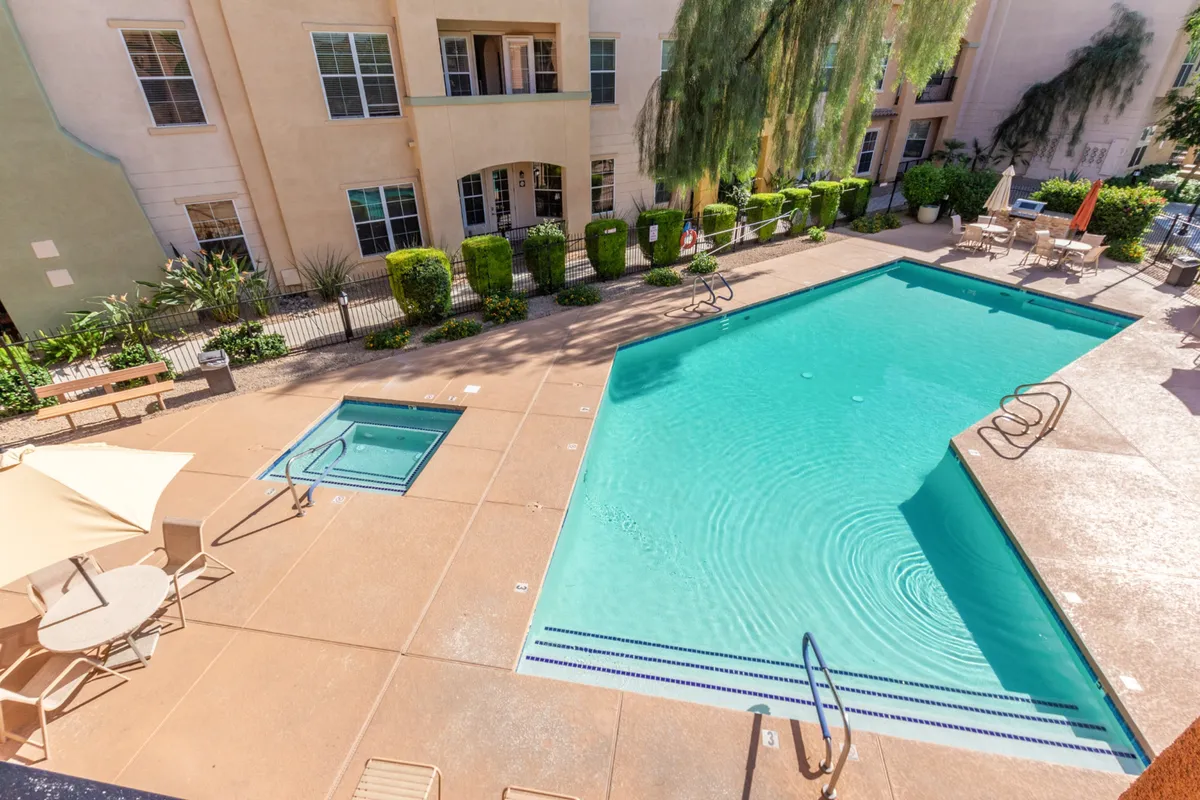 This image captures the community’s swimming pool and hot tub, surrounded by lush greenery and inviting lounge chairs. Residents can be seen enjoying the water, socializing by the poolside, and relaxing in the communal outdoor space.